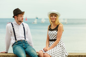 Loving couple retro style dating on sea coast