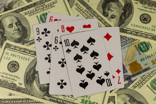 Playing cards on the American one hundred dollar bills background