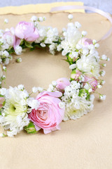 Wedding wreath with rose, ranunculus and chrysanthemum flowers.