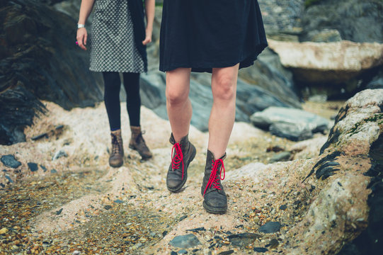 The legs of two woman walking on beach