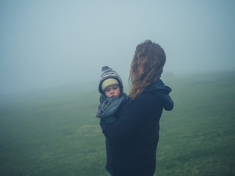 Mother with baby in the mist