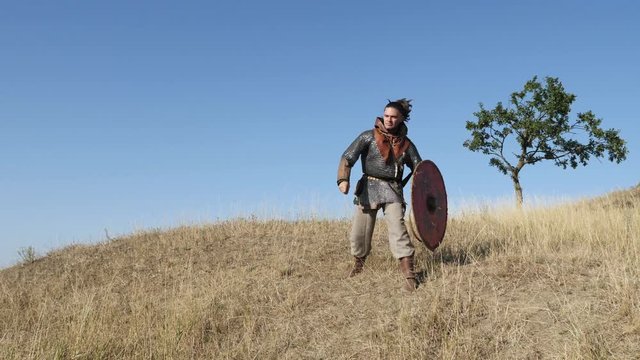 Warrior Viking throws a spear in the battle. Preparing for battle.