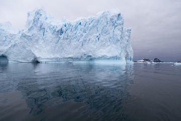 Obraz na płótnie Canvas A huge iceberg has calved from a glacier. Showing beautiful blue ice