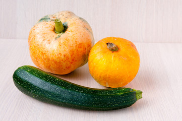 Large and small pumpkins and green zucchini