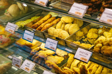 Different kinds of desserts in the store in Prague. Czech desserts. Cakes, pastries and pies are on sale on the display window in the desserts shop.