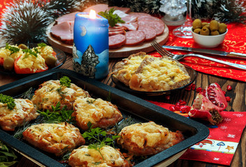 Christmas baked chops with cheese and cold cuts platter, served on the old wooden table