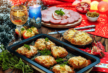 Christmas baked chops with cheese and cold cuts platter, served on the old wooden table