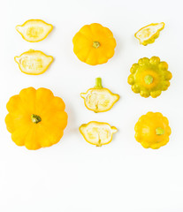 Creative layout (pattern) made of small yellow pumpkins. Flat lay. Food concept. Vegetables isolated on white background. Vegetables abstract background