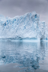 Fototapeta na wymiar A huge iceberg has calved from a glacier. Showing beautiful blue ice