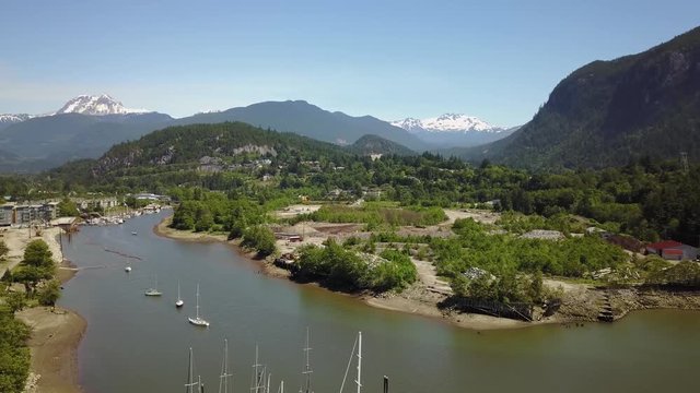 Aerial 4k footage of a marina in a small town, Squamish, located North of Vancouver, British Columbia, Canada. Taken during a bright sunny summer, day.
