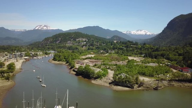 Aerial 4k footage of a marina in a small town, Squamish, located North of Vancouver, British Columbia, Canada. Taken during a bright sunny summer, day.
