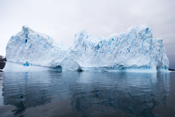 A huge iceberg has calved from a glacier. Showing beautiful blue ice