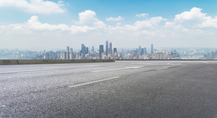 Road pavement and city skyline