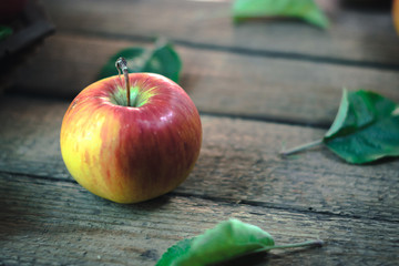 Fresh apple on an old wooden table.