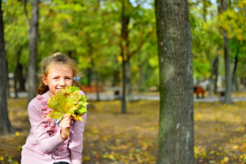 Pretty little girl relax on beauty autumn landscape background