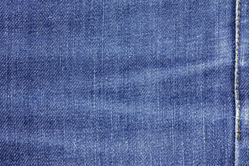Naklejka premium Denim jeans fabric texture or denim jeans background with seam for beauty clothing. fashion business design and industrial construction idea concept.