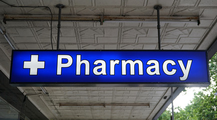 Unspecified universal Pharmacy neon sign above the entrance to the chemist drug store