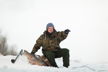 Russin Spearfishing with speargun shot a big fish under the ice of the river Volga near Volgograd...