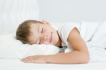 Little boy sleeping in bed