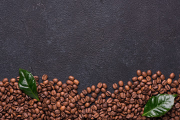 Coffe beans with coffe leaves on black background