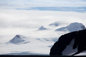 Wind and clouds sweep over this mountain in Antarctica.