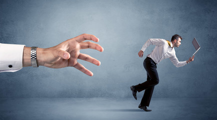 Businessman running from hand
