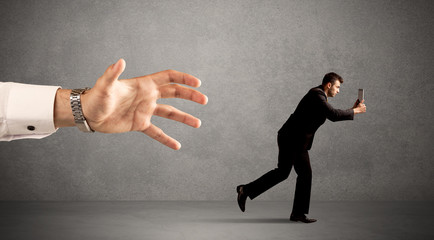 Businessman running from hand