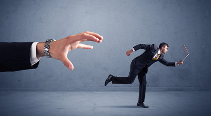 Businessman running from hand