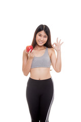 Obraz na płótnie Canvas Beautiful Asian healthy girl show OK sign with apple.