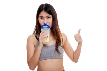 Beautiful Asian healthy girl show thumbs up  drink whey protein.