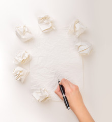 Writing hand in crumpled paper