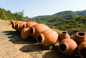 Large clay jugs for wine are put up for sale.