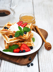waffles with strawberries,  blueberry and coffee