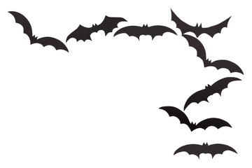 Silhouettes of volatile bats carved out of black paper are isolated on white