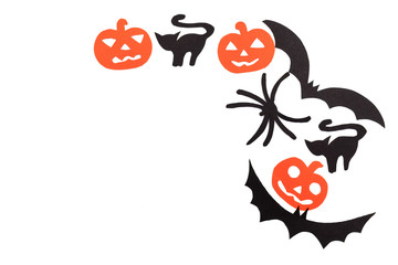 Silhouettes of black volatile bats, cats, orange pumpkins, cats and spider carved out of black...