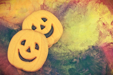 Fototapeta premium Colorful Halloween pumpkin cookie with copy space