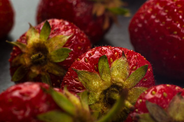 Fototapeta premium fresh ripe strawberries on black ceramic plate
