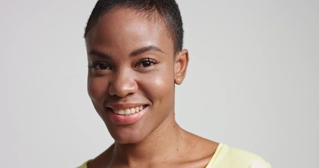 closeup Portrait of a smiling happy attractive young black model with beautiful skin isolated on white
