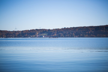 Fototapeta na wymiar Autumn at Lake Starnberg, bright blue sky, glittering water