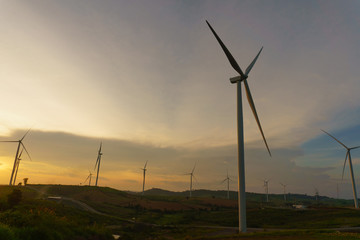 Fototapeta na wymiar Wind turbine power generator at twilight