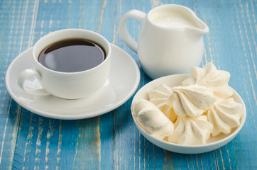 breakfast with a cup of coffee and meringue/breakfast with a cup of coffee and meringue on a blue...