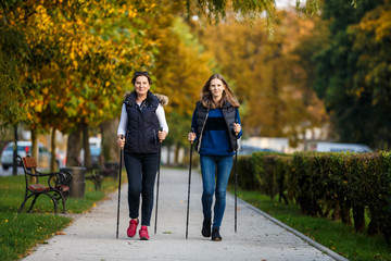 Nordic walking - active people working out in park