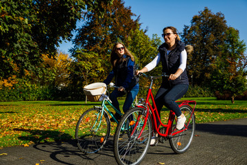 Fototapeta na wymiar Healthy lifestyle - people riding bicycles in city park