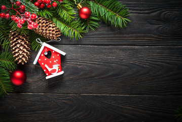 Christmas background with fir tree and decorations at dark wooden table.