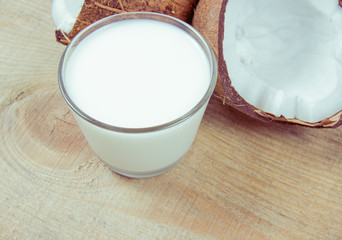 Coconut with coconut milk on wooden background.