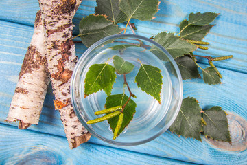 A glass of birch juice on wooden background