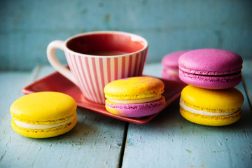 Gentle colorful macaroons on color wooden background