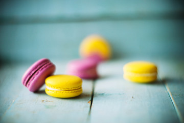 Group of pastel color macaroons on blue textured shabby chic background, with room for copy space