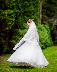 Gorgeous bride turn in the park