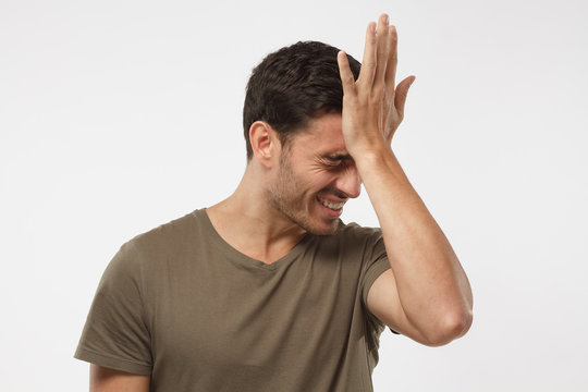 Disappointed stressed out guy making facepalm gesture with hand. Face palm concept